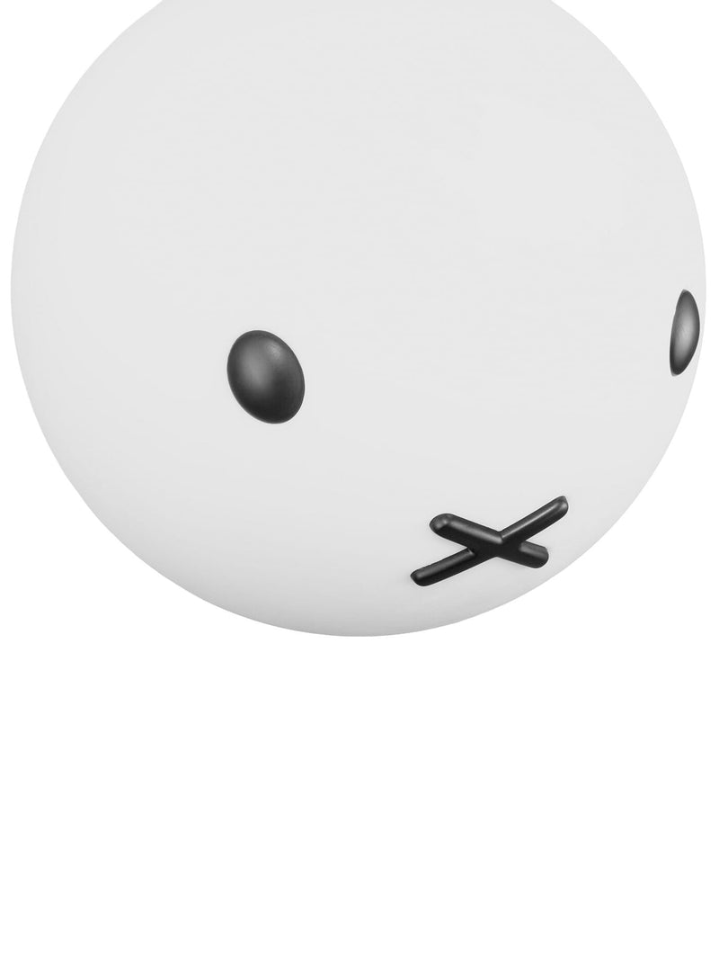 Gros plan sur la lampe Bolleke x Miffy de Fatboy montrant le visage doux de Miffy et sa lueur blanche chaude.