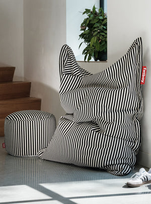 Fatboy Point Terry pouf multifonctionnel en tissu éponge rayé utilisé comme siège d’appoint ou repose-pieds.