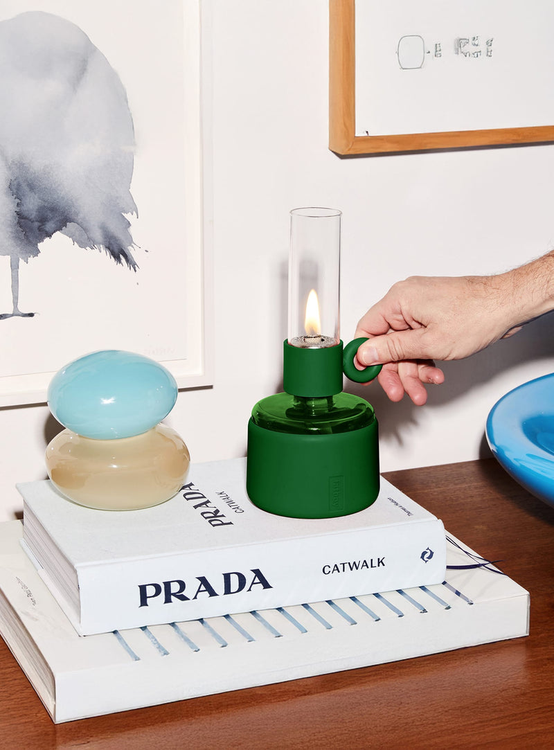 Créez une ambiance feu de camp à l’intérieur avec la Flamtastique XS. Cette lampe à huile moderne diffuse une lumière douce et réglable pour des soirées mémorables.